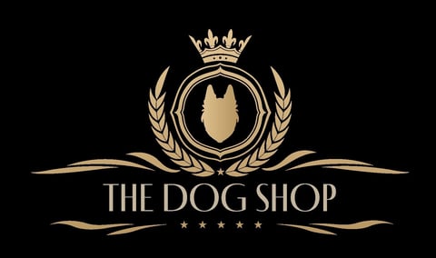 The Dog Shop logo featuring a gold dog silhouette in a crest with crown, laurel wreaths, and decorative flourishes on black background